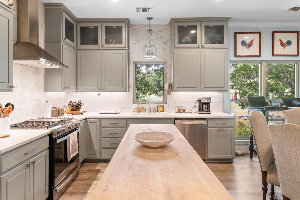290 Cardinal Hill Road Ingram, TX 78025 - Photo 9 of 57 a kitchen with stainless steel appliances granite countertop a stove a sink and a refrigerator