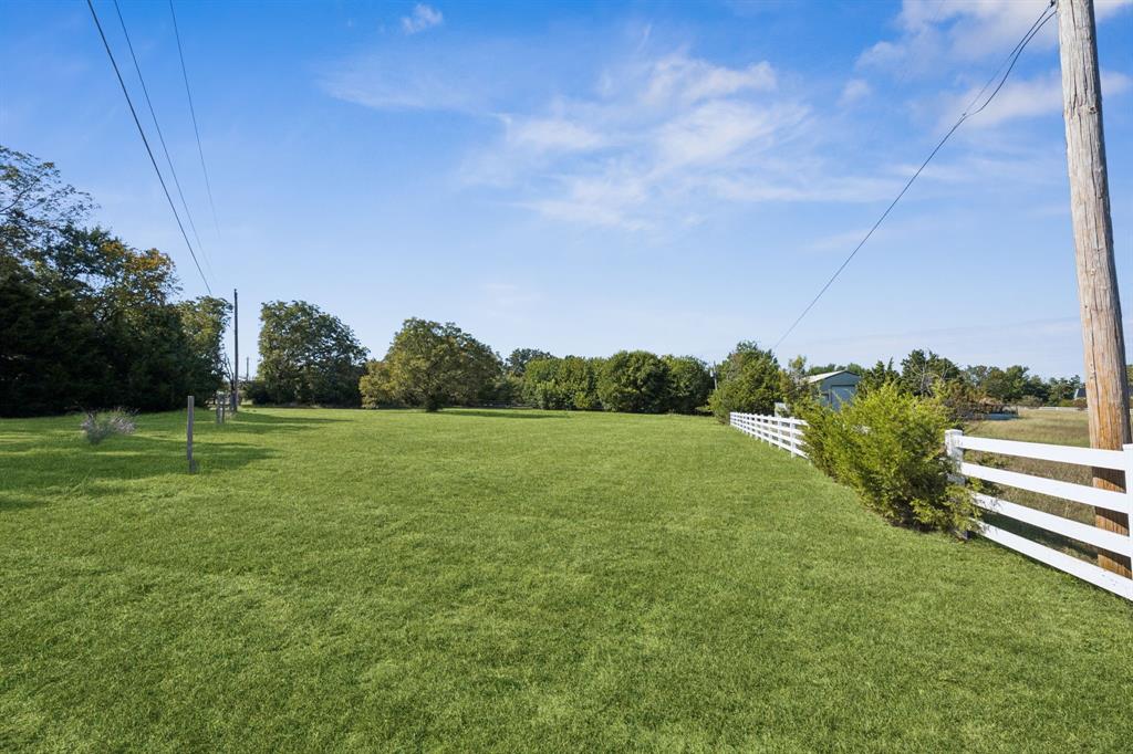6 North Star Road Lucas, TX 75002 - Photo 8 of 11 a view of a green field with wooden fence