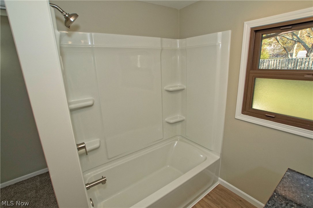 8063 Middlesex Road Mentor, OH 44060 - Photo 12 of 35 A brand new tub and surround and luxury vinyl plank flooring.