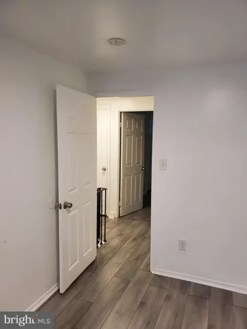 an empty room with wooden floor and closet