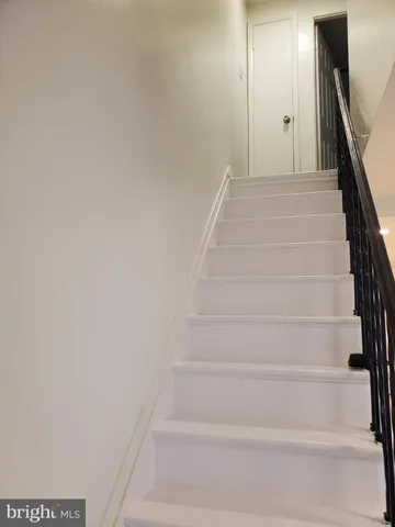 a view of staircase with white walls