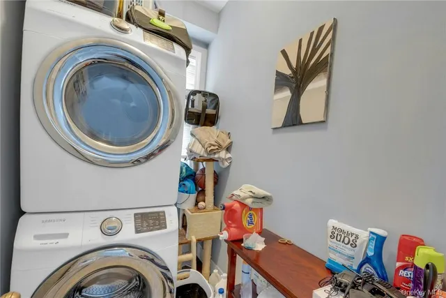 a utility room with dryer washer and a view of kitchen