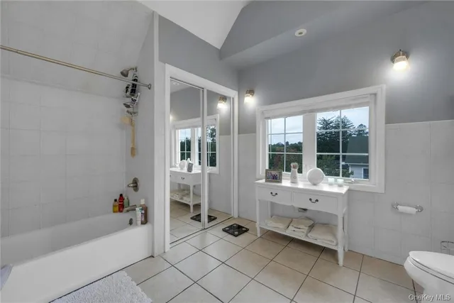 a bathroom with a bathtub and a window