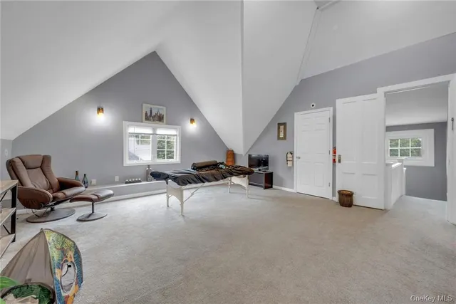 a view of a livingroom with furniture and a window