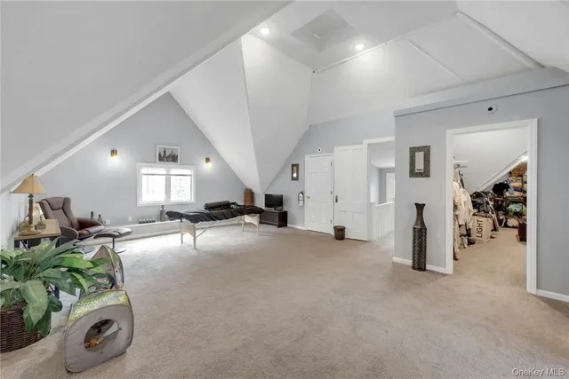 a view of a livingroom with furniture and a hallway