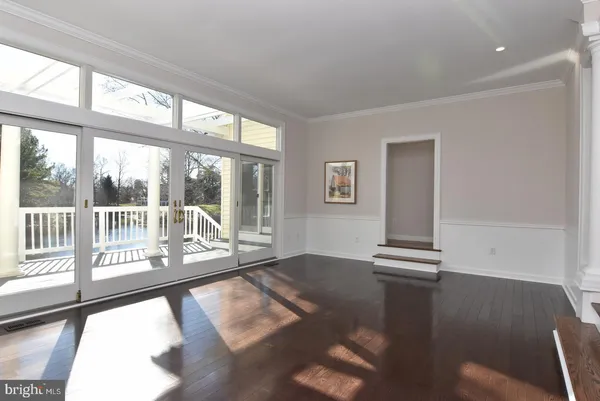 a view of an empty room with a window and fireplace