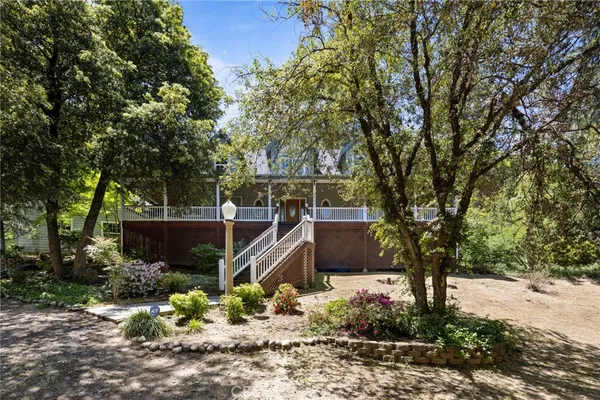 a view of a house with wooden floor next to a yard