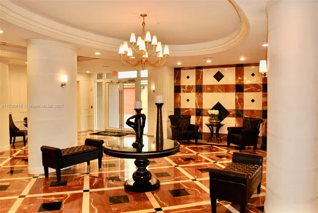 a living room with dining table and a chandelier