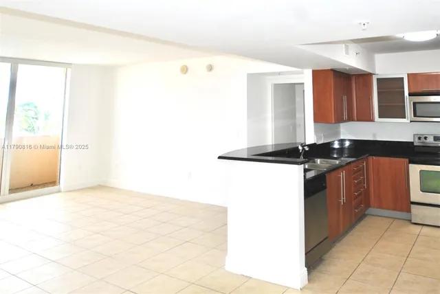 a kitchen with a sink and a stove top oven