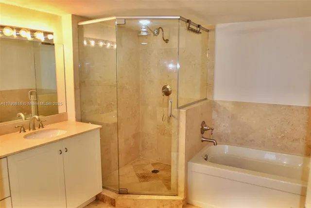 a bathroom with a shower a sink and a mirror