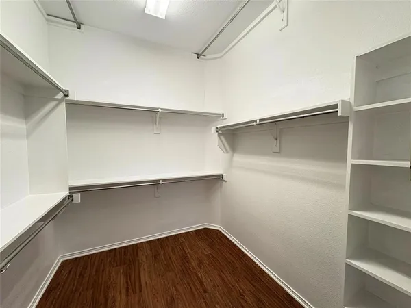 a view of storage and utility room with wooden floor