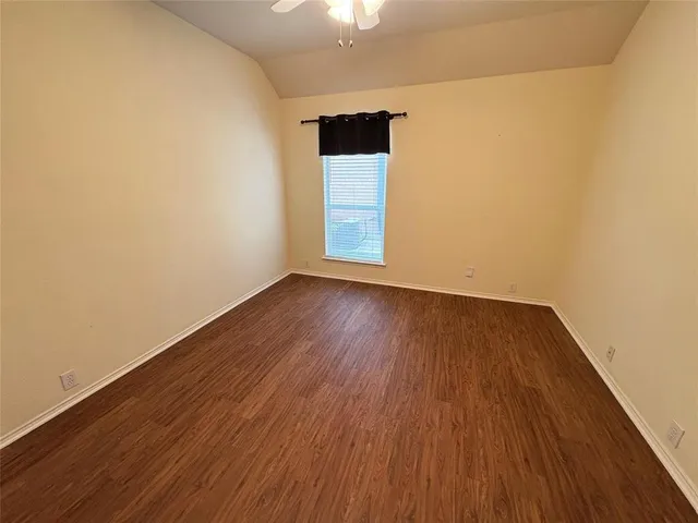 a view of a small space with wooden floor and a window