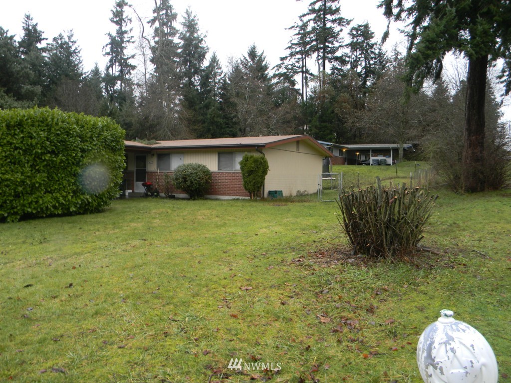 515 Roe Street Steilacoom, WA 98388 - Photo 2 of 9 a view of a backyard with large trees