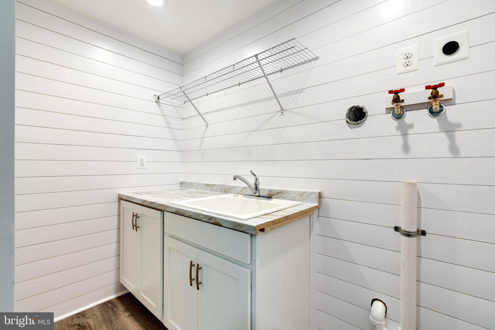 1011 Gahle Road Westminster, MD 21157 - Photo 42 of 52 Laundry with Storage and Sink & Shiplap Walls
