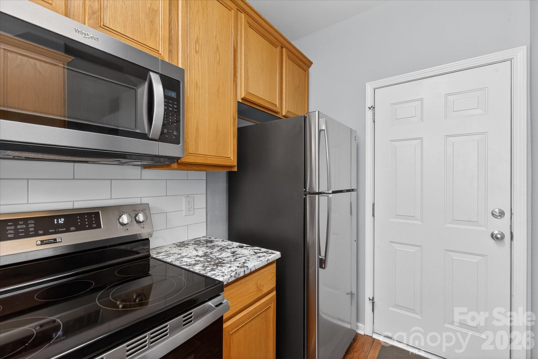 3066 Priory Ridge Drive, Unit 337 Fort Mill, SC 29707 - Photo 11 of 31 a kitchen with stainless steel appliances granite countertop a refrigerator and a stove top oven