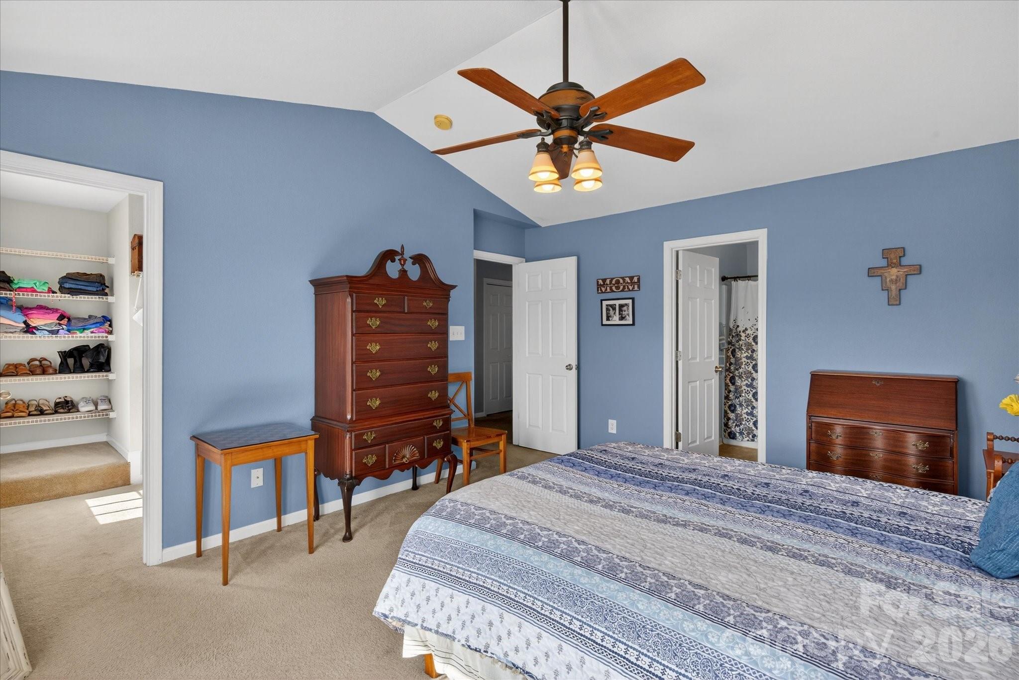 3066 Priory Ridge Drive, Unit 337 Fort Mill, SC 29707 - Photo 16 of 31 a bedroom with a bed and a chandelier