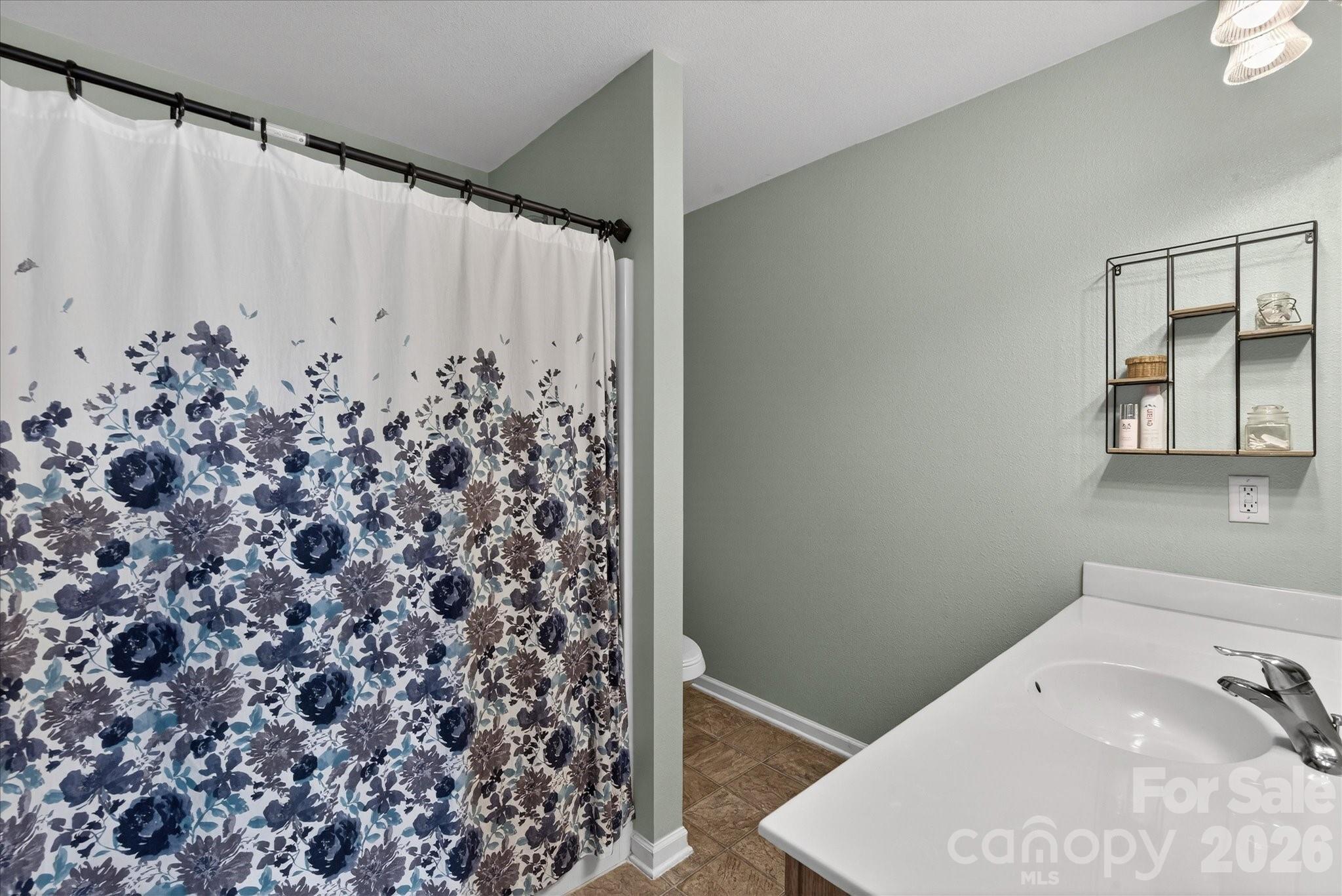 3066 Priory Ridge Drive, Unit 337 Fort Mill, SC 29707 - Photo 18 of 31 a bathroom with a shower curtain and a sink