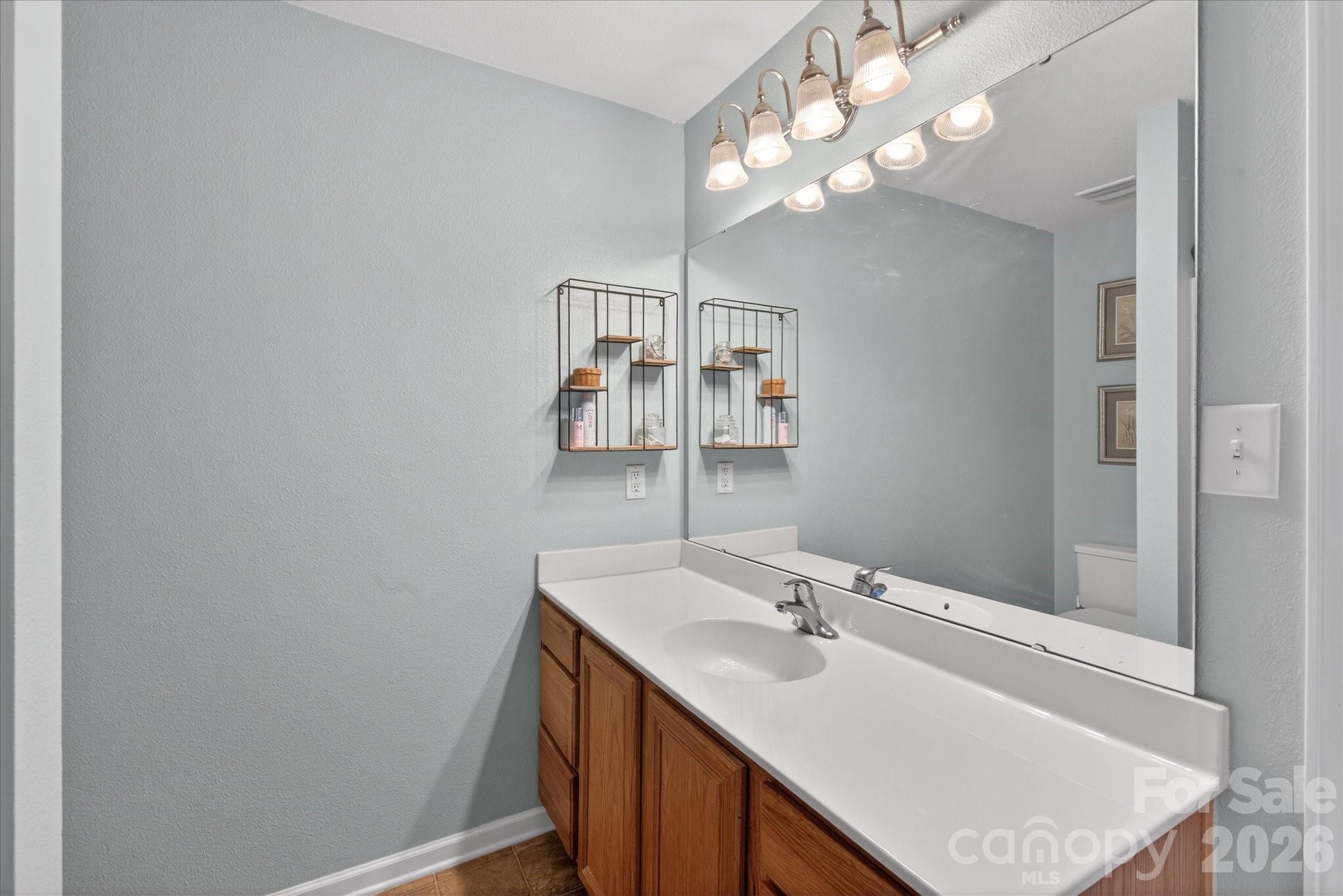 3066 Priory Ridge Drive, Unit 337 Fort Mill, SC 29707 - Photo 19 of 31 a bathroom with a sink vanity and a mirror