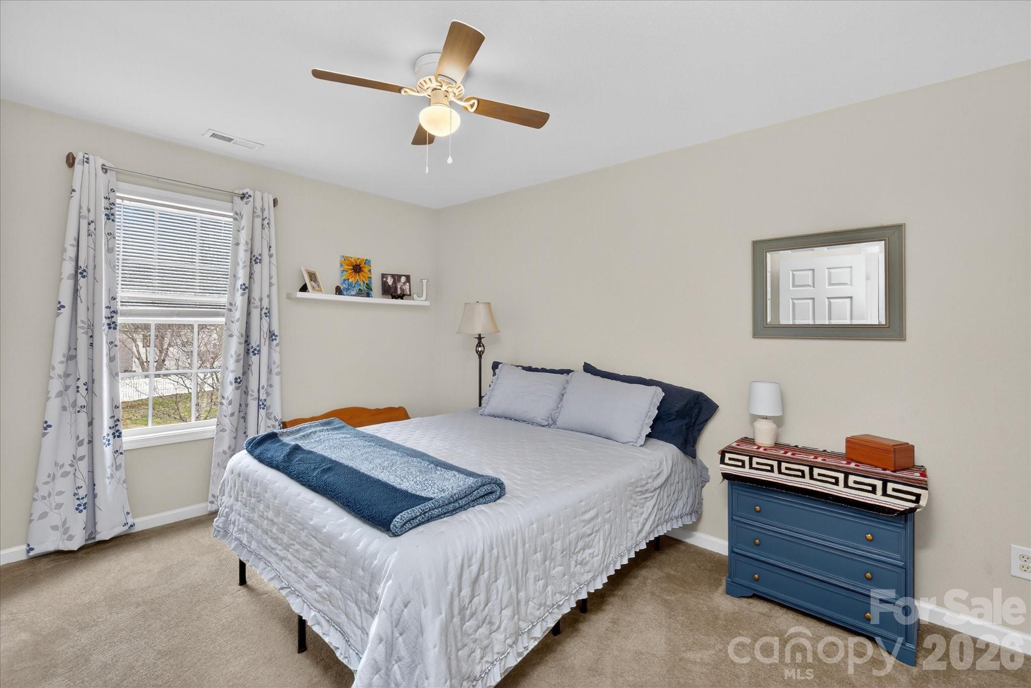 3066 Priory Ridge Drive, Unit 337 Fort Mill, SC 29707 - Photo 20 of 31 a bedroom with a bed and a chandelier