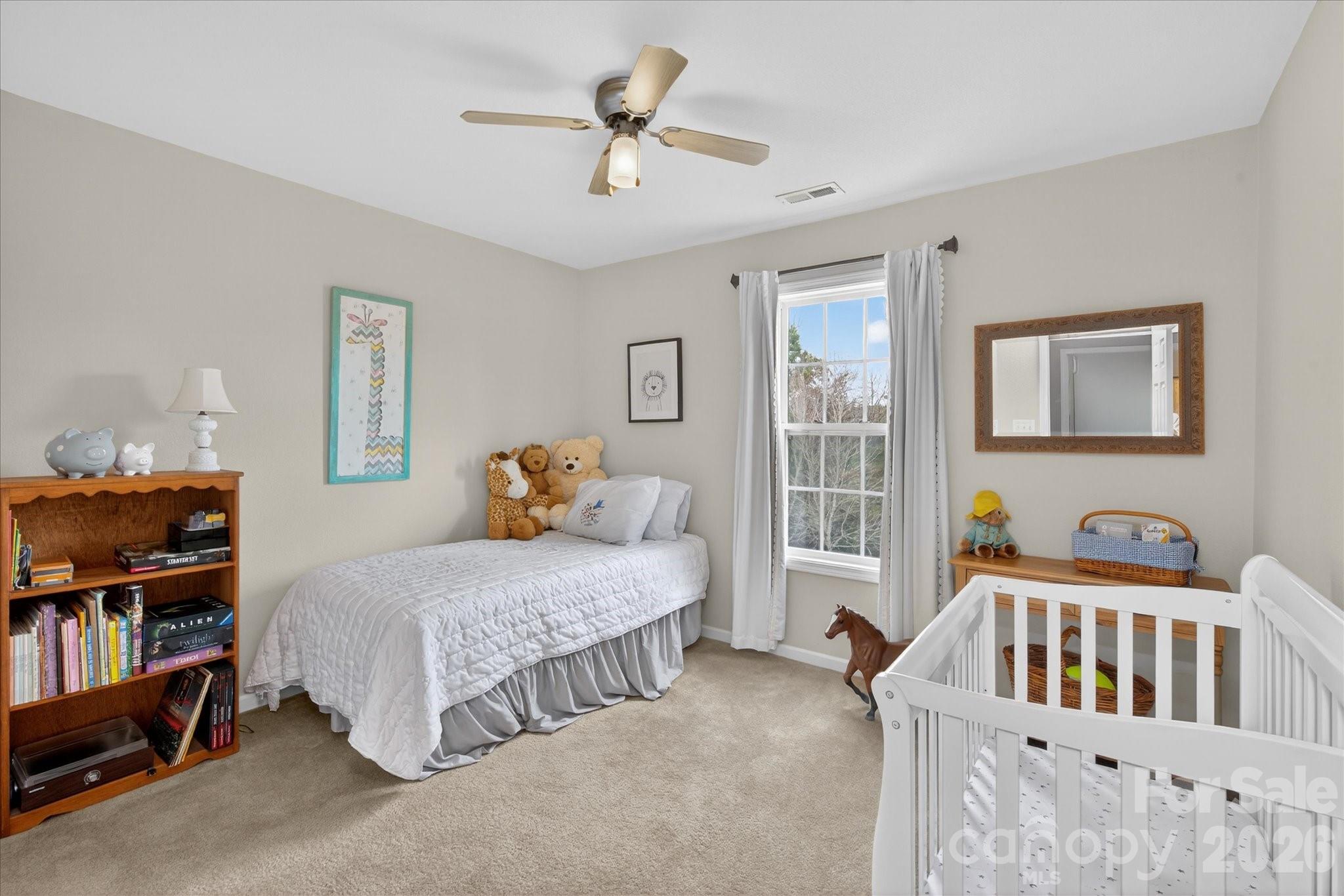 3066 Priory Ridge Drive, Unit 337 Fort Mill, SC 29707 - Photo 21 of 31 a bedroom with bed and a book shelf