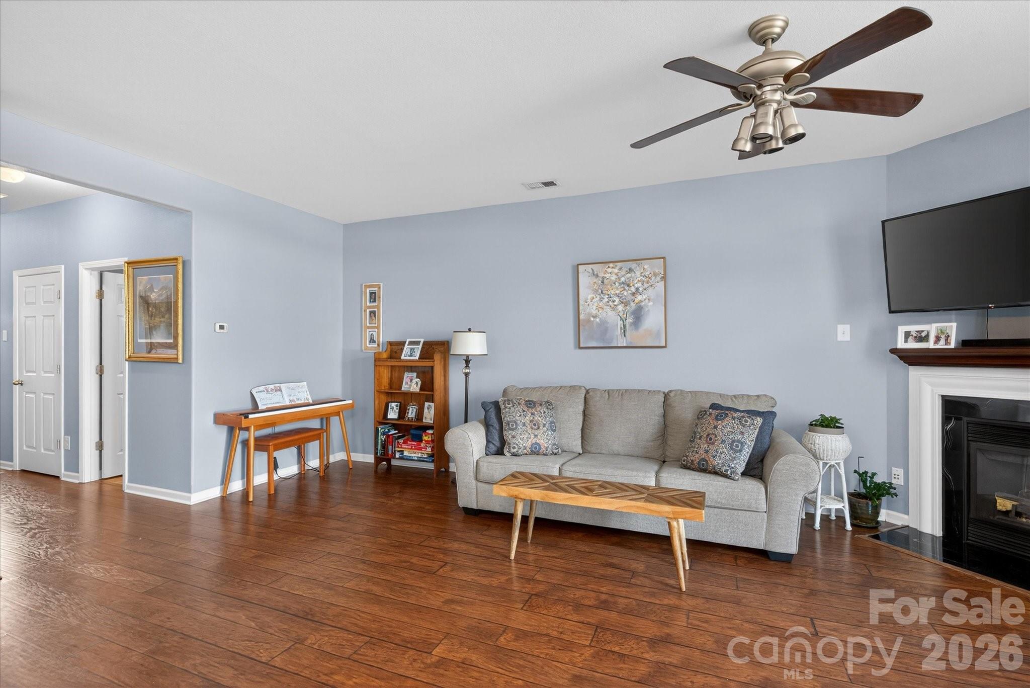 3066 Priory Ridge Drive, Unit 337 Fort Mill, SC 29707 - Photo 5 of 31 a living room with furniture a fireplace and a flat screen tv