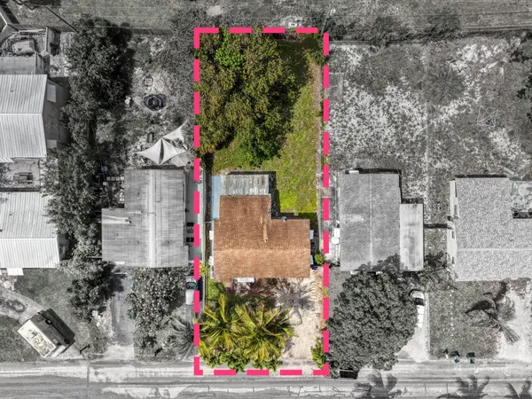 an aerial view of residential houses with outdoor space and seating