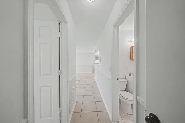 a view of a closet area with an empty room