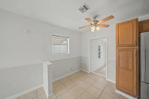 a utility room with closet and mirror