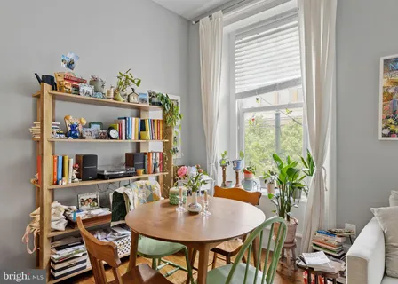 a view of a dining room with furniture and a potted plant