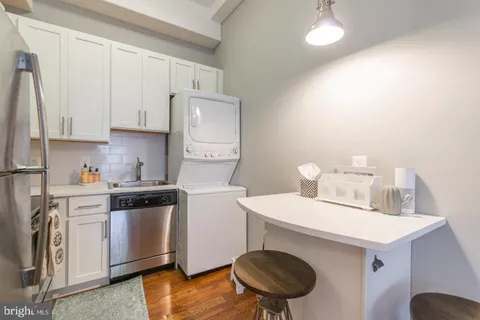 a kitchen with a sink a stove and cabinets
