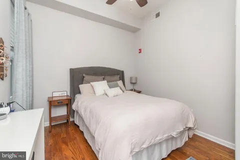 a large bed sitting in a bedroom next to a bathroom sink