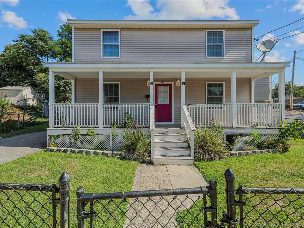 a front view of a house with a yard table and chairs