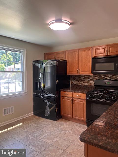 1232 Palmer Road, Unit 111 Fort Washington, MD 20744 - Photo 6 of 45 a kitchen with granite countertop a stove top oven a sink dishwasher a dining table and chairs with wooden floor