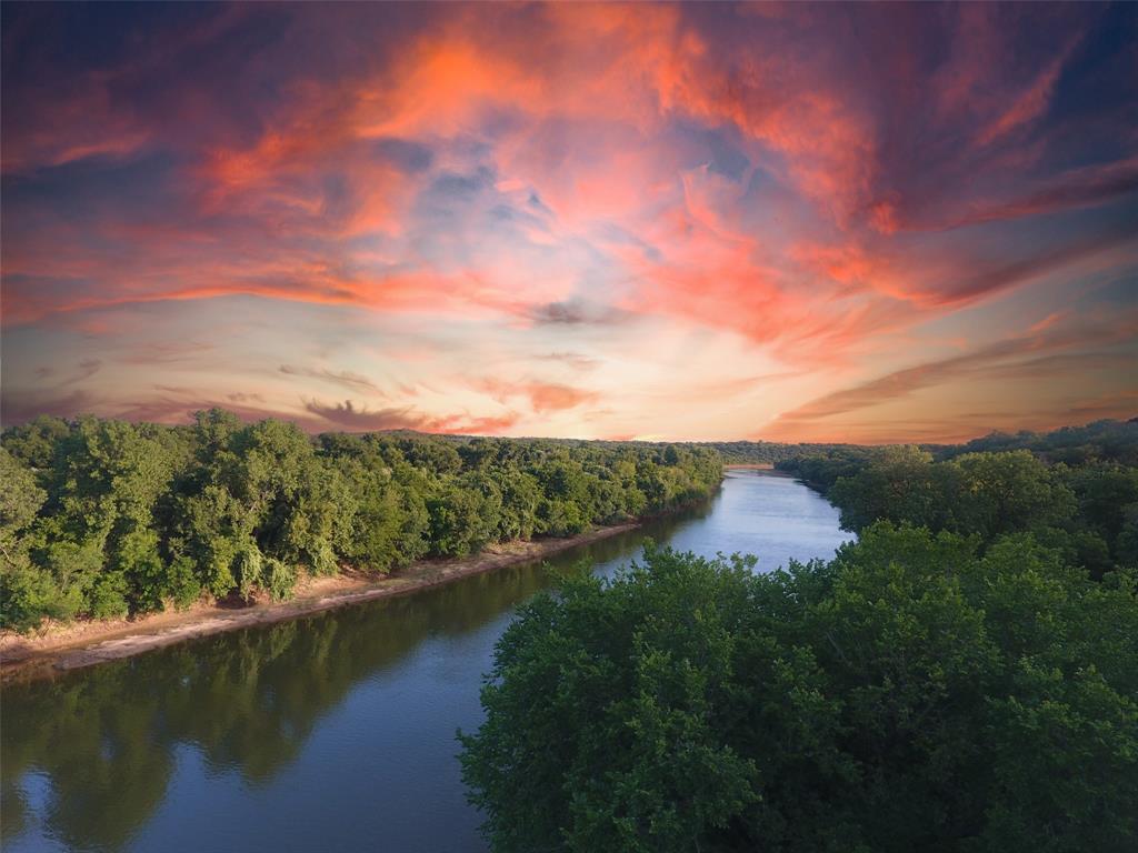 9710 Bellechase Road Granbury, TX 76049 - Photo 2 of 40 a view of a lake from a yard