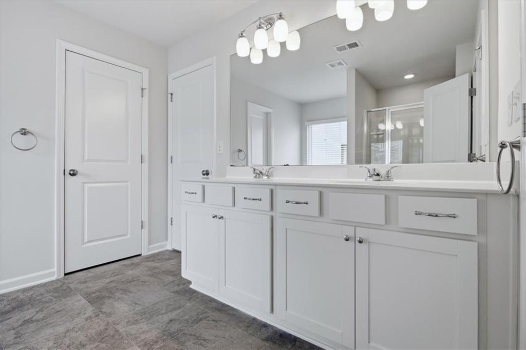 585 Summit Point Canton, GA 30114 - Photo 15 of 30 a view of cabinets a sink and a refrigerator a mirror