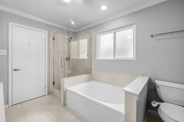 a white bath tub sitting next to a toilet