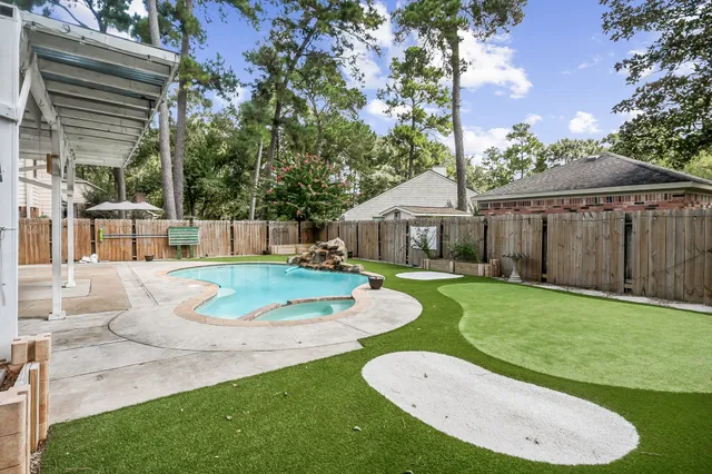 a view of a house with a swimming pool and a yard