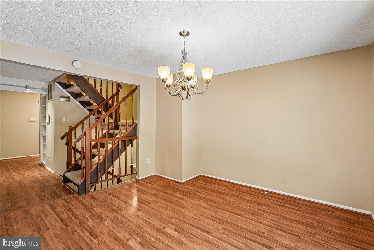 2331 Middle Creek Lane Reston, VA 20191 - Photo 19 of 78 a view of a livingroom with wooden floor and a ceiling fan
