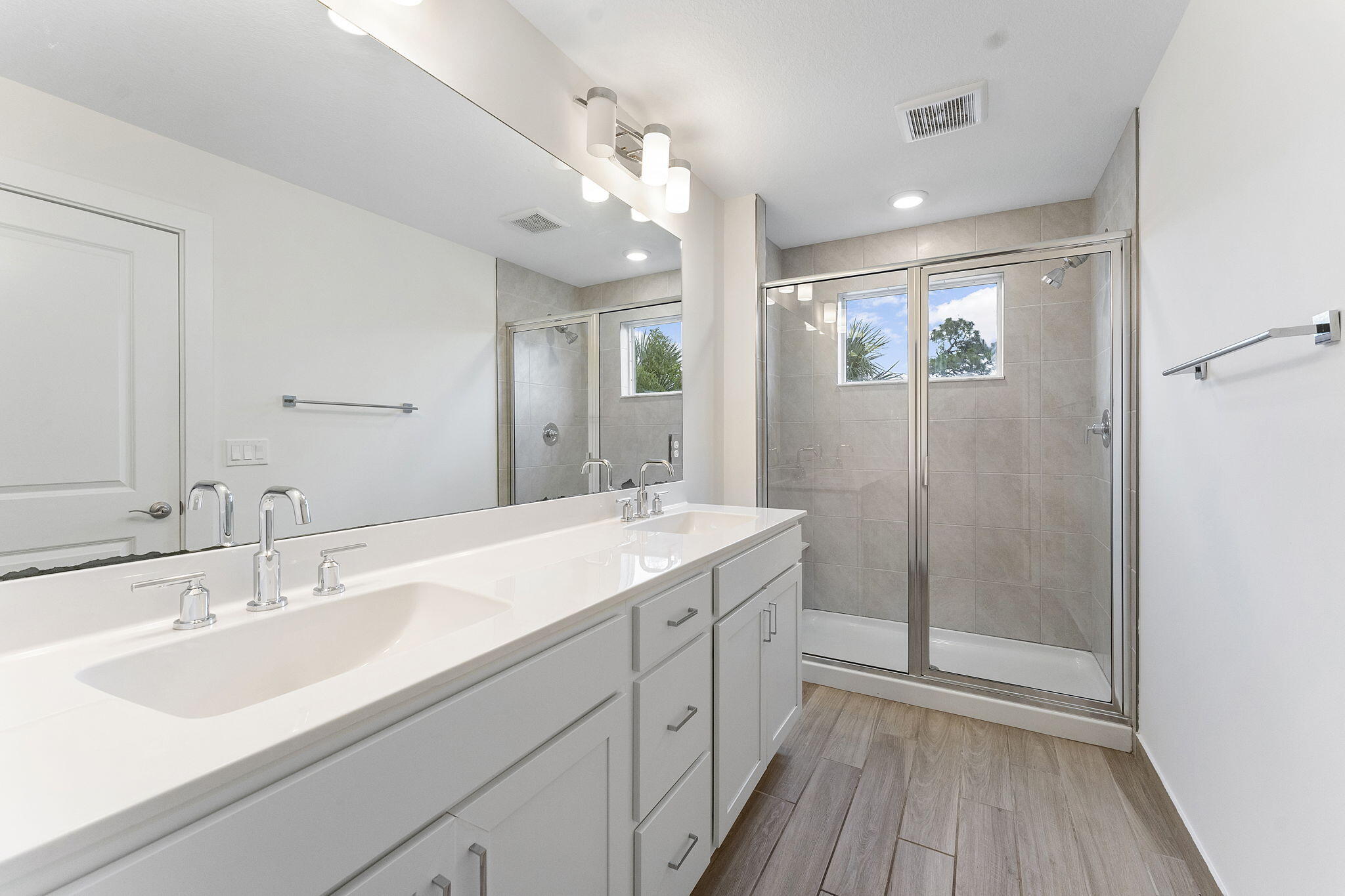 247 Preserve Trail North Stuart, FL 34994 - Photo 18 of 34 a spacious bathroom with a double vanity sink mirror and shower
