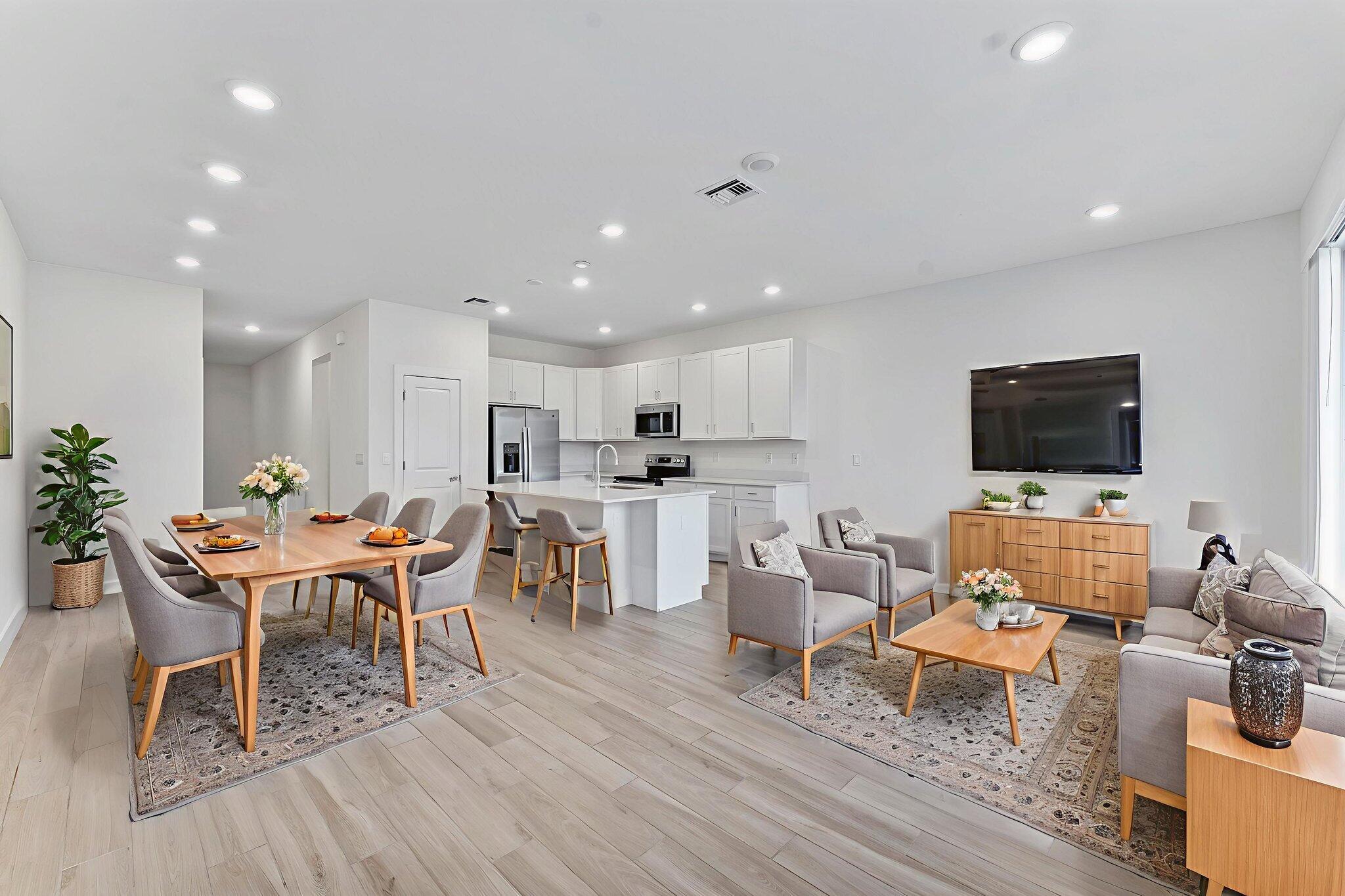 247 Preserve Trail North Stuart, FL 34994 - Photo 3 of 34 a living room with furniture a flat screen tv and kitchen view