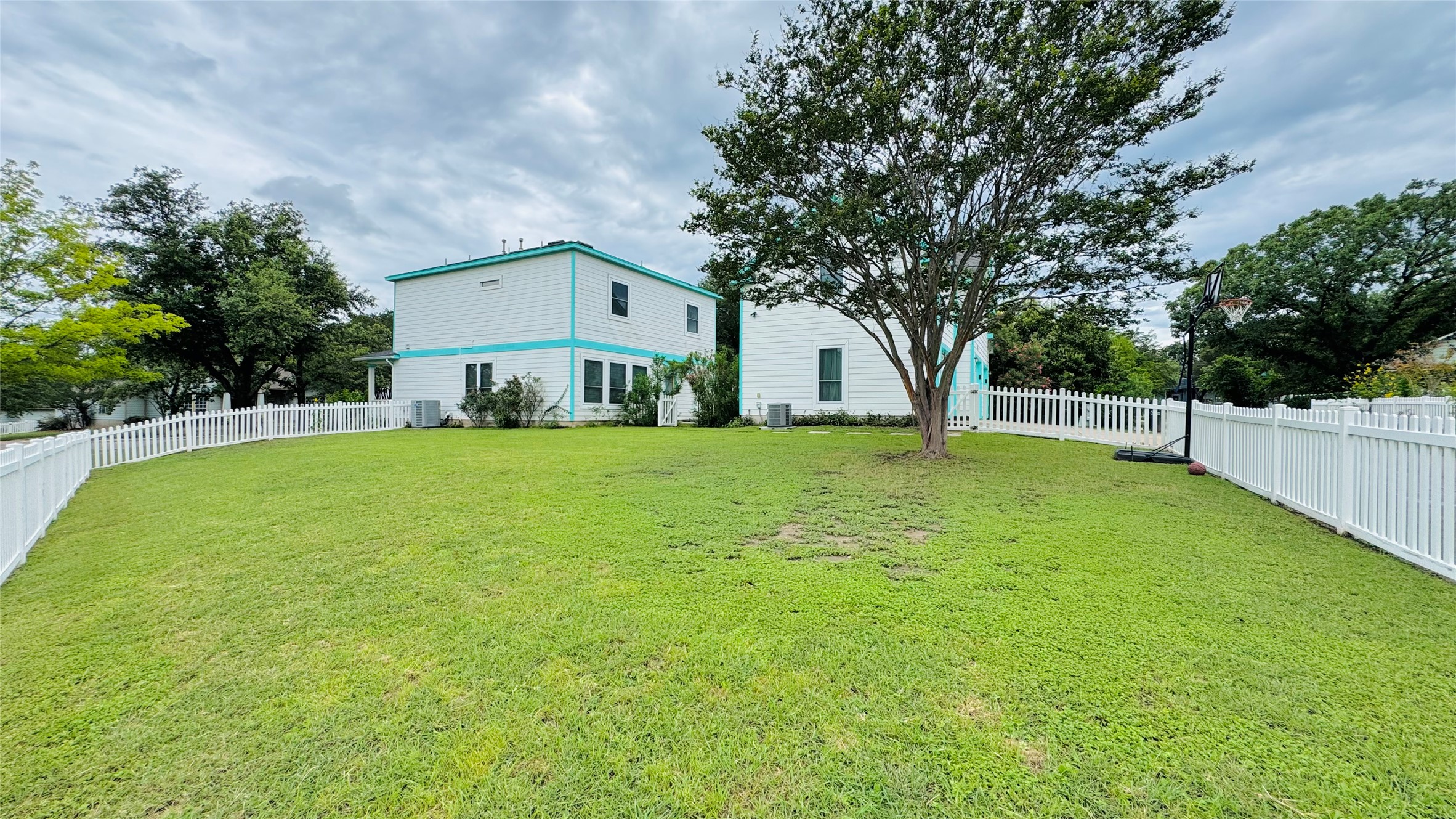 401 Witte Road Kyle, TX 78640 - Photo 9 of 9 A generous backyard, perfect for play, offers ample green space and a classic white picket fence.