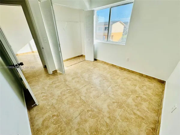 a view of an empty room and staircase