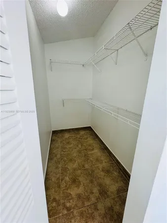a view of bathroom with a sink and mirror