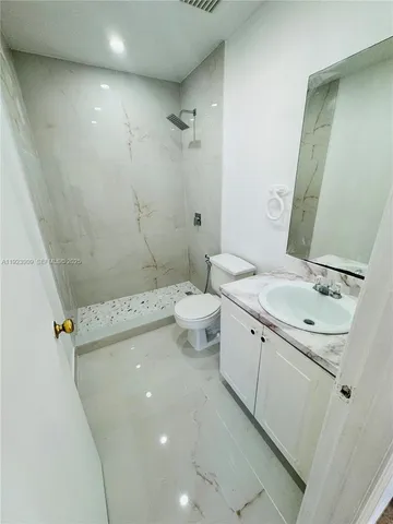 a bathroom with a sink toilet and shower