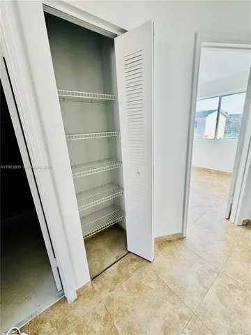 a bathroom with a glass door shower and a window