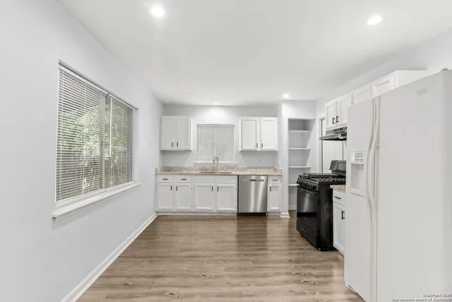 a kitchen with a refrigerator stove and sink