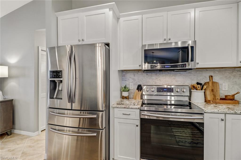 Undisclosed Address Naples, FL 34110 - Photo 11 of 23 a kitchen with stainless steel appliances a refrigerator stove and microwave