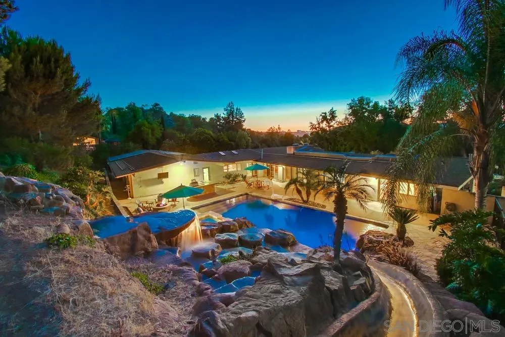 a view of a lake with a house swimming pool and outdoor space