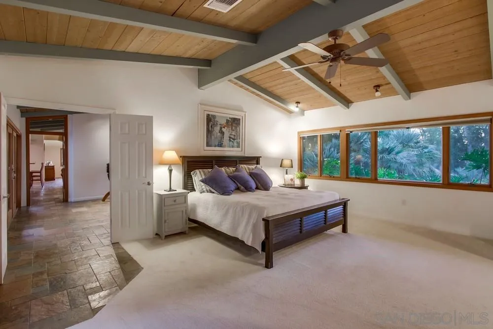 13401 Stone Canyon Road Poway, CA 92064 - Photo 16 of 25 a spacious bedroom with a bed and a large window