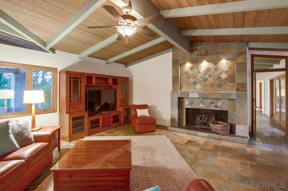 13401 Stone Canyon Road Poway, CA 92064 - Photo 9 of 25 a living room with furniture a fireplace and a large window